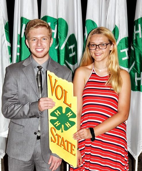Two 4H Students holding a 4H Vol State banner