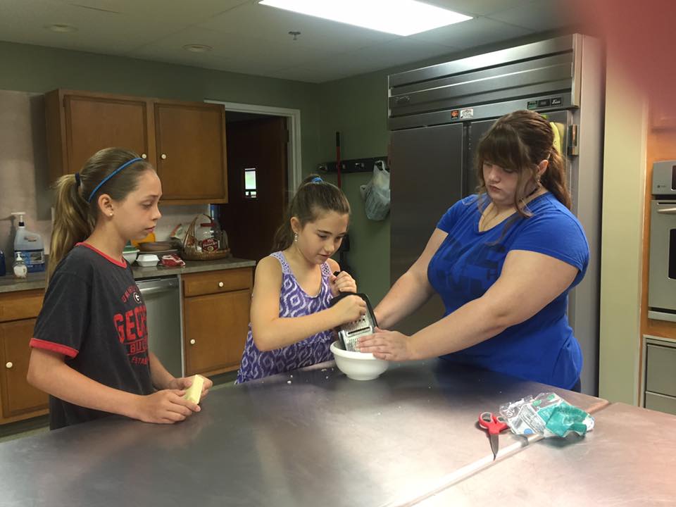 A 4-H Volunteer and two 4-Her's working on an experiment
